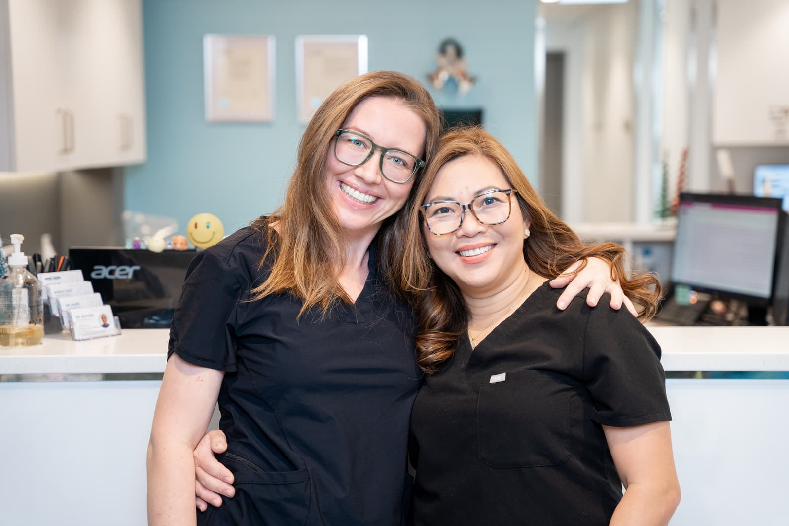 Two Dental Choice team members at the front desk of the 25 Mount Royal clinic
