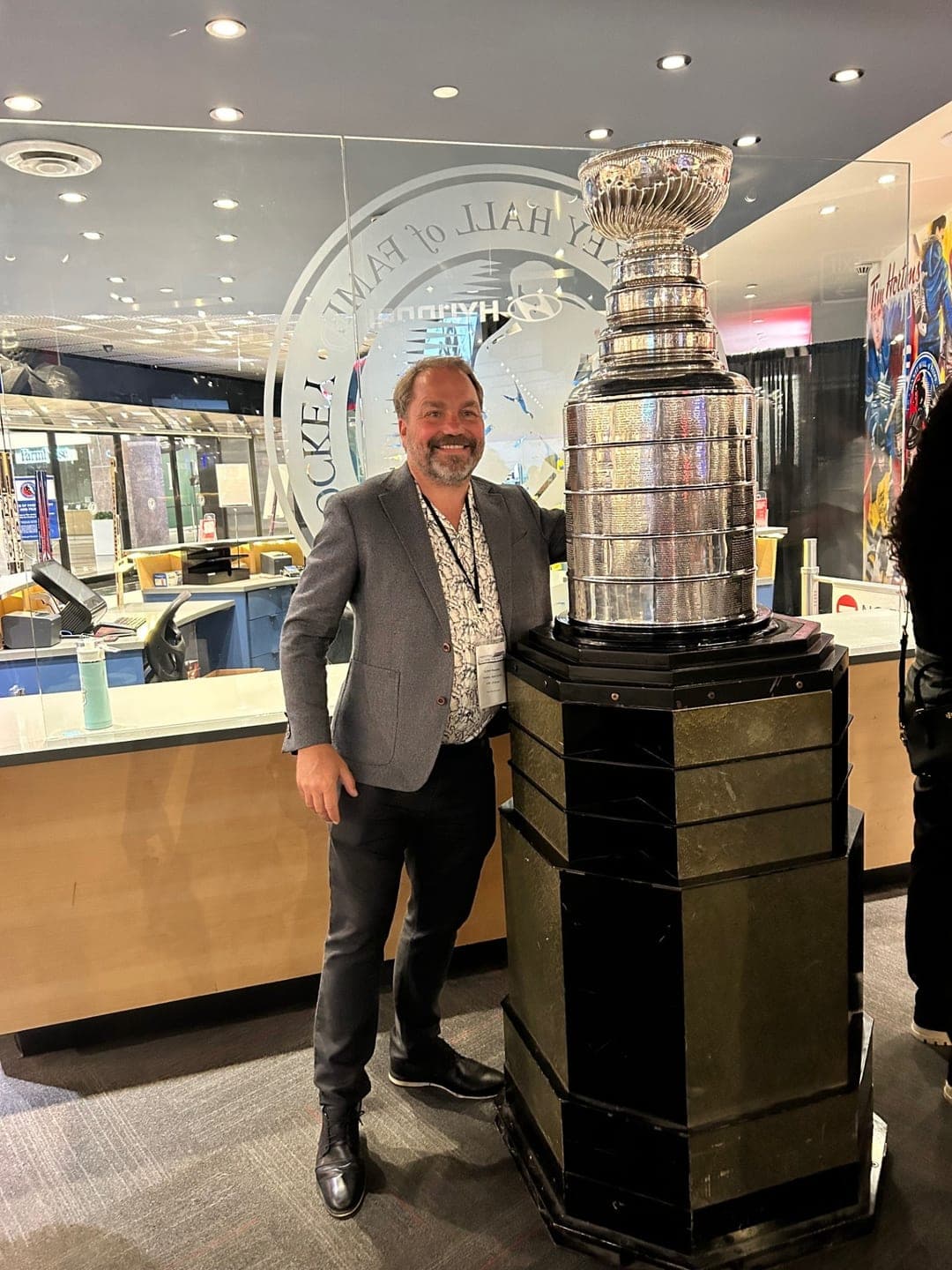A Dental Choice dentist beside the Stanley Cup at the Hockey Hall of Fame