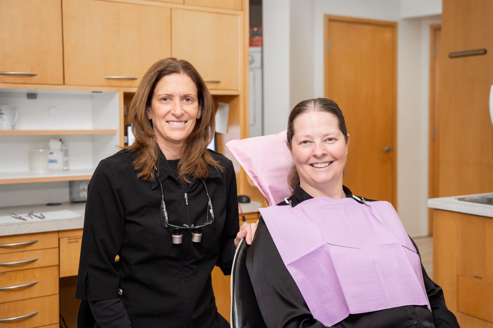 A Dental Choice dentist beside a patient in the chair