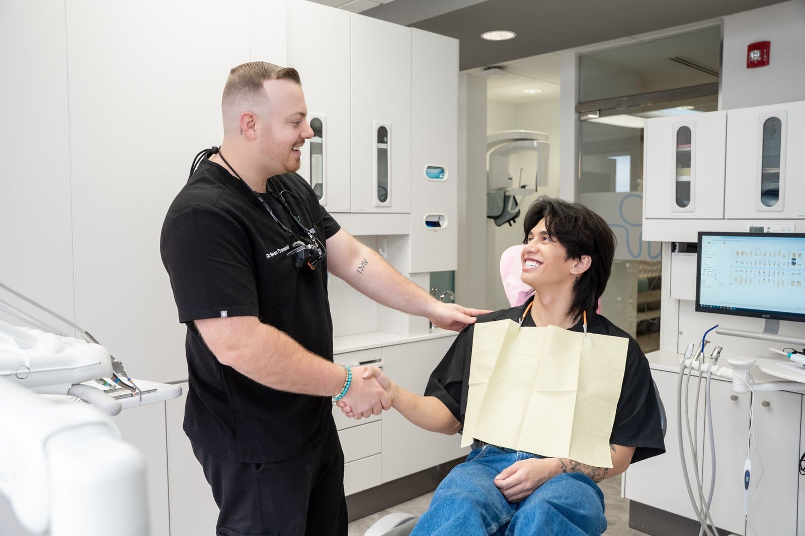 A Dental Choice dentist shaking hands with a patient