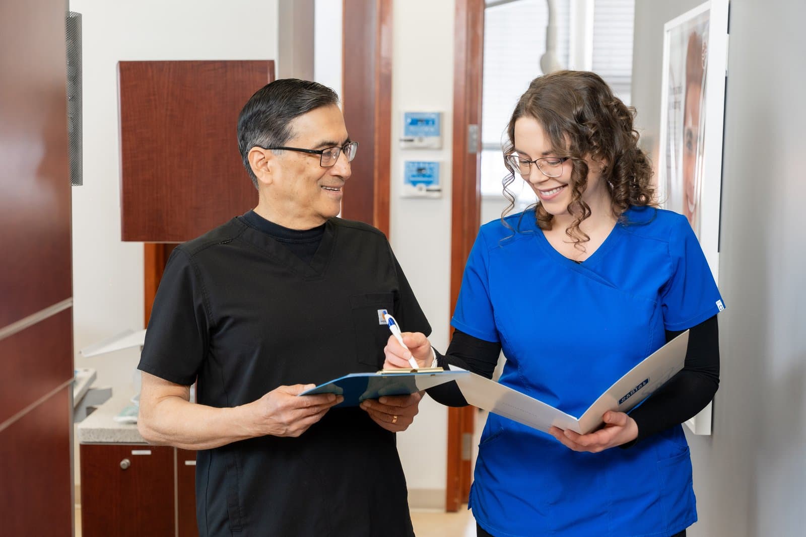 Two Dental Choice clinicians reviewing notes together